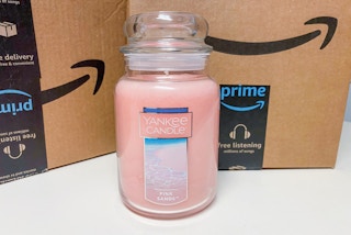 a yankee candle in front of some amazon boxes