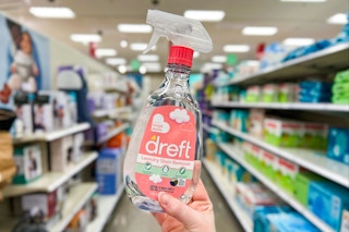 hand holding a dreft laundry stain remover in a target aisle