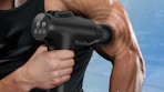 a person using a deep tissue massage gun