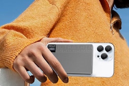 woman holding phone with charger attached to the back