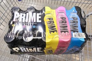 a 15-pack of prime hydration drinks in a cart