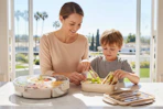 a woman and boy packing food