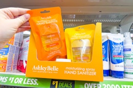 hand holding up an ashley belle collection hand sanitizers