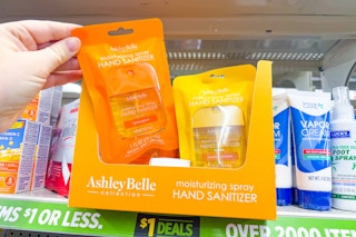 hand holding up an ashley belle collection hand sanitizers