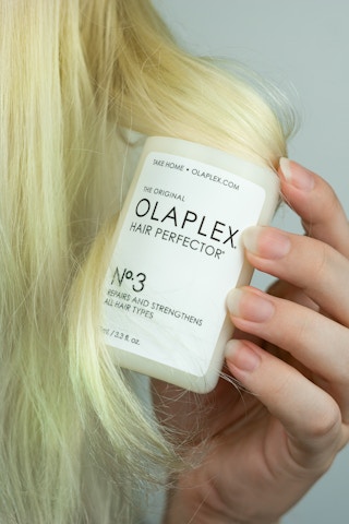 hand holding Olaplex Hair care