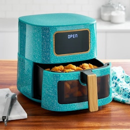 stock image of a teal air fryer on a counter