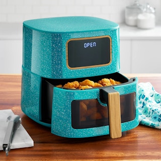 stock image of a teal air fryer on a counter