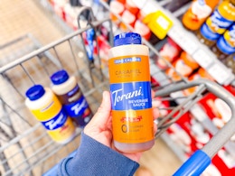 A Torani Zero Calorie Beverage Sauce held over Walmart shopping cart