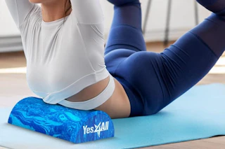 a woman using a half round foam roller