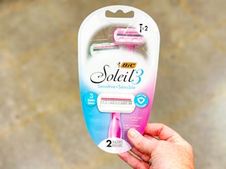 hand holding a pack of bic soleil 3 razors in walmart aisle