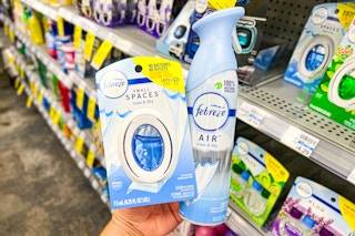 hand holding two febreze products in a store aisle