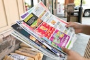 someone looking at newspaper coupon inserts