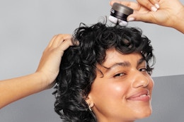 a woman using dry shampoo