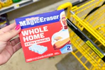 hand holding a package of mr clean magic erasers