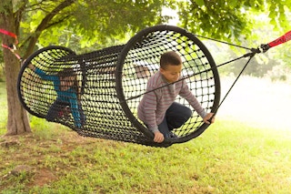 2 kids playing in a 6 foot rope climbing tunnel connected to 2 trees