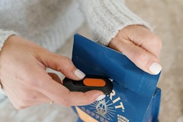 a woman using a slice mini box cutter