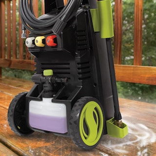 A Sun Joe pressure washer cleaning an outside deck.