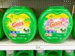 two containers of Gain detergent on a shelf
