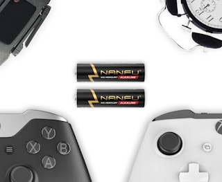 a pair of batteries next to game controllers