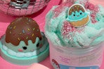 up close of Maya the ice cream slime in the container and charm