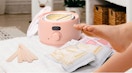 a pink waxing kit on a table