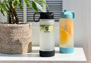 water bottle filled with cucumber and oranges displayed