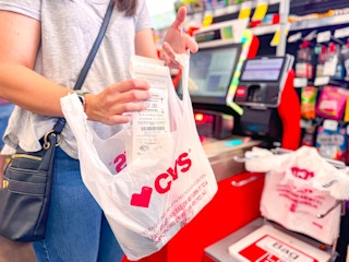 a woman checking out at CVS self checkout
