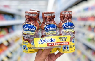 hand holding 6-pack of Splenda diabetes care shakes in aisle