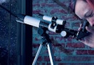 person looking through the telescope