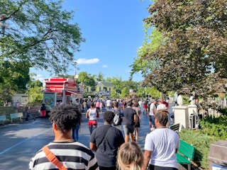 Crowds inside a Six Flags amusement park