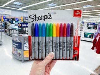 hand holding pack of sharpies inside Walmart