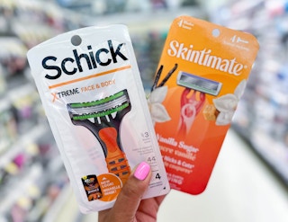 hand holding one pack of Schick and Skintimate razors