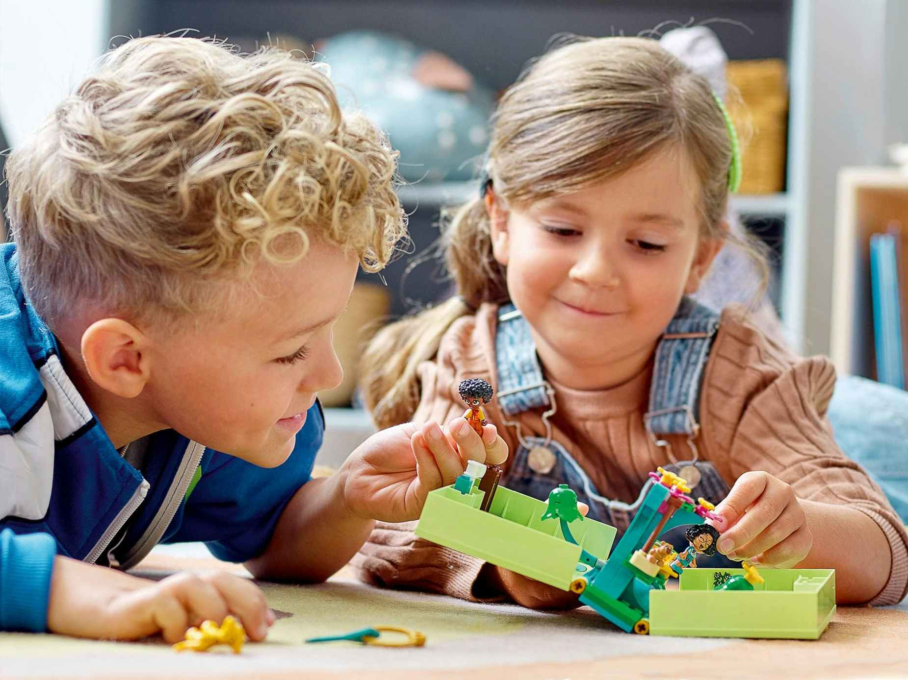 Two kids playing with a storybook Lego set