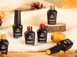 nail polish bottles on display next to small pumpkins