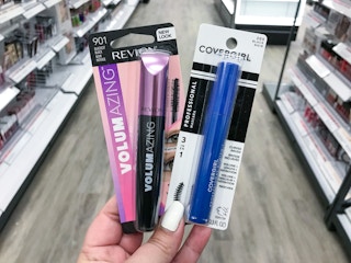 hand holding revlon and covergirl mascara at target