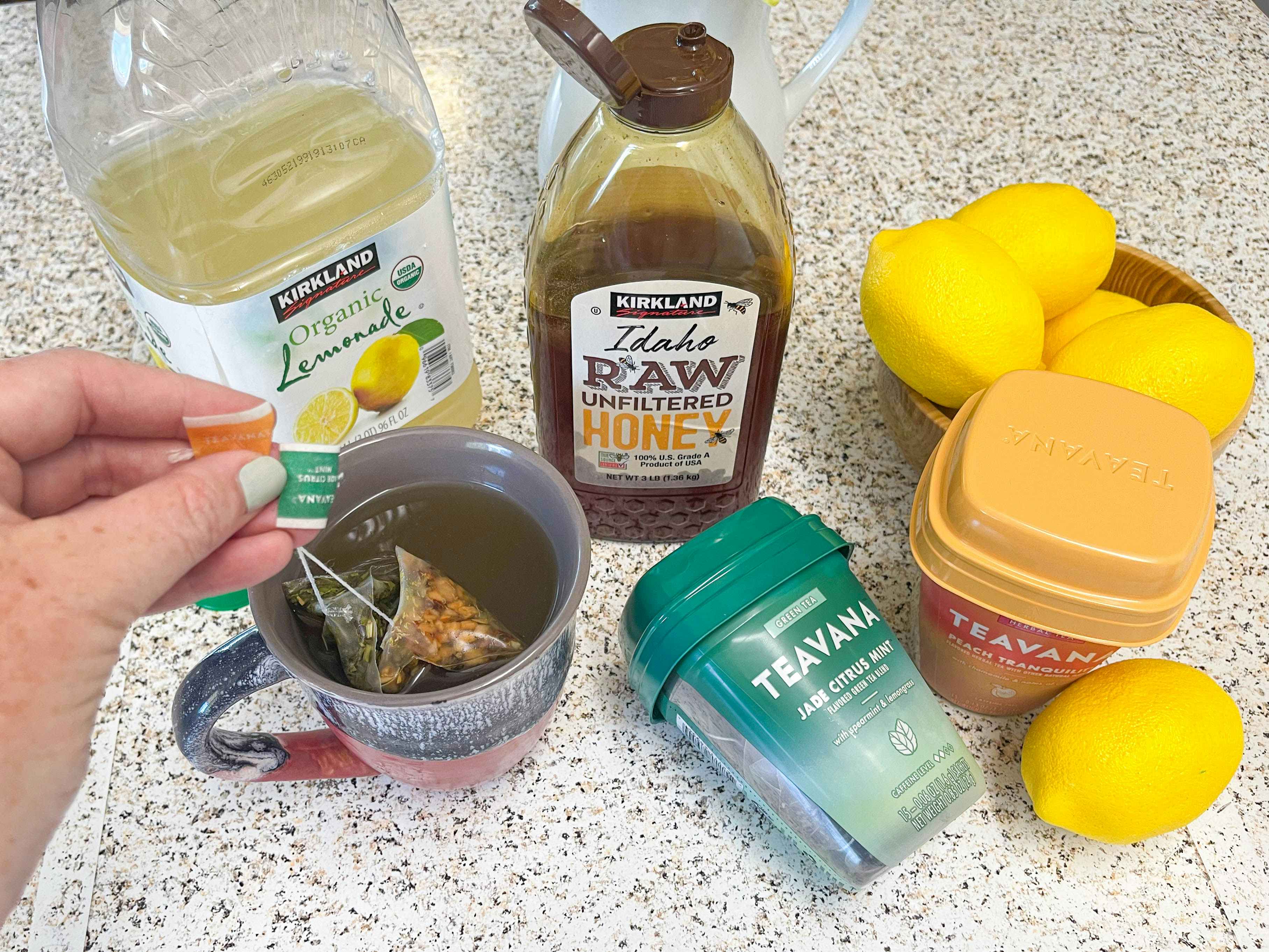 diy starbucks medicine ball drink with tea, honey, and lemonade on counter