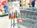 a hobby lobby cart next to a 60% off christmas sign 