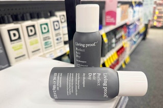 living proof dry shampoo bottles on a shelf