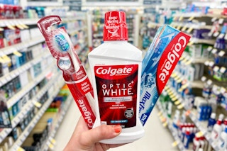 hand holding colgate dental products