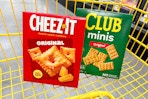 cheez-it and club crackers in a yellow shopping cart