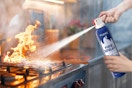 Fire extinguisher being used on stove fire