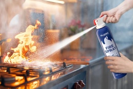 Fire extinguisher being used on stove fire