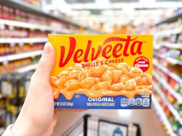 hand holding a box of velveeta shells and cheese