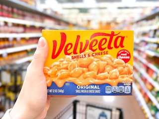 hand holding a box of velveeta shells and cheese