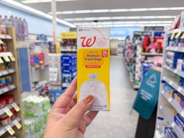 hand holding pack of walgreens brand trash bags