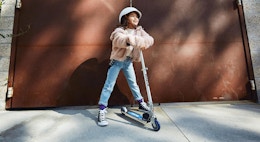 a kid with a Razor scooter outside