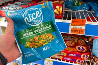 person holding a bag of frozen vegetables