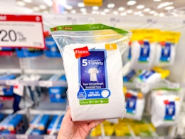 hand holding a pack of hanes kids' t-shirts at target