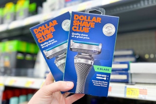 hand holding two Dollar Shave Club starter kits at Walmart