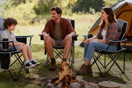 family sitting around camp fire